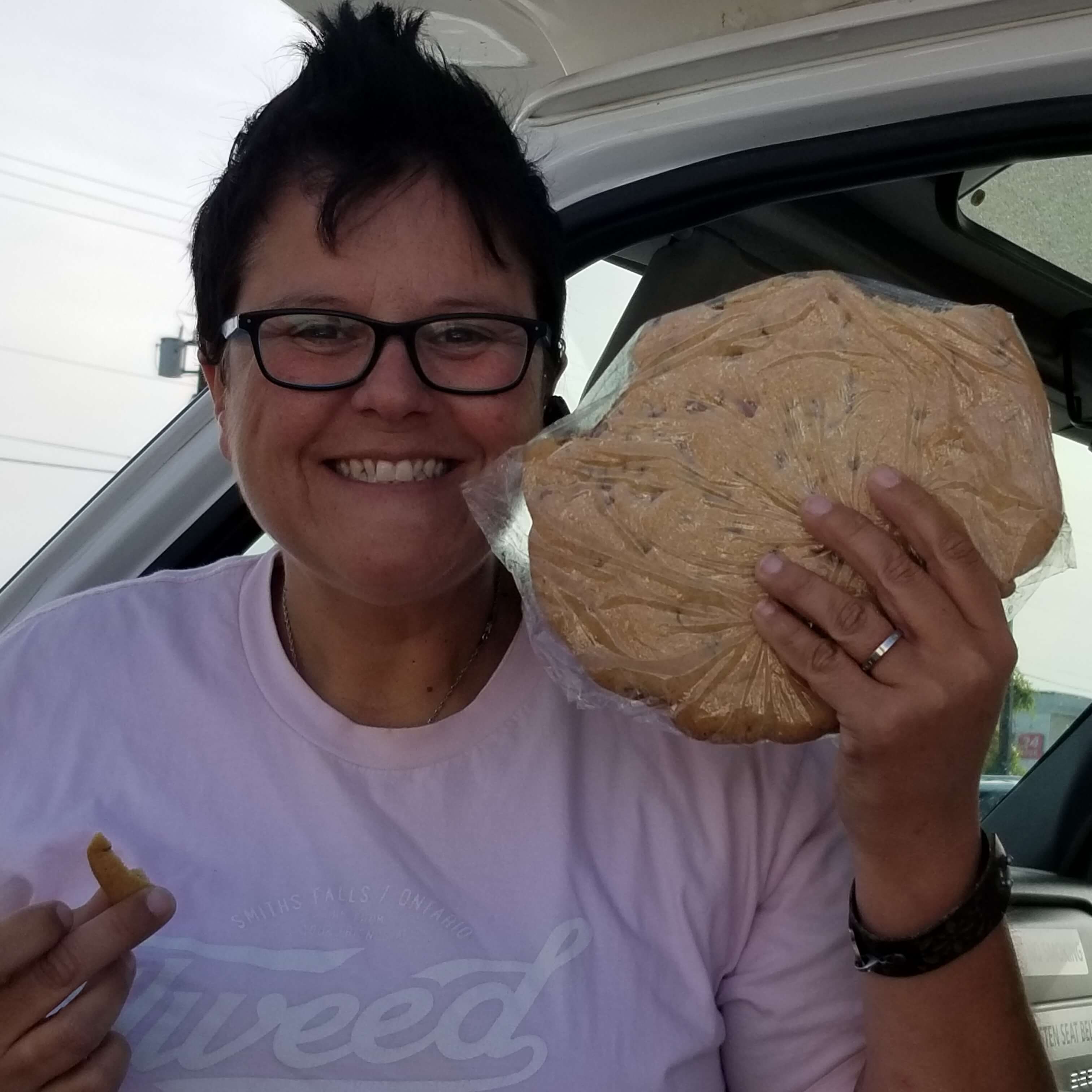 Driver Dianne holding giant cookie